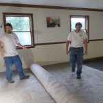 Rolling the carpet out after the padding is down